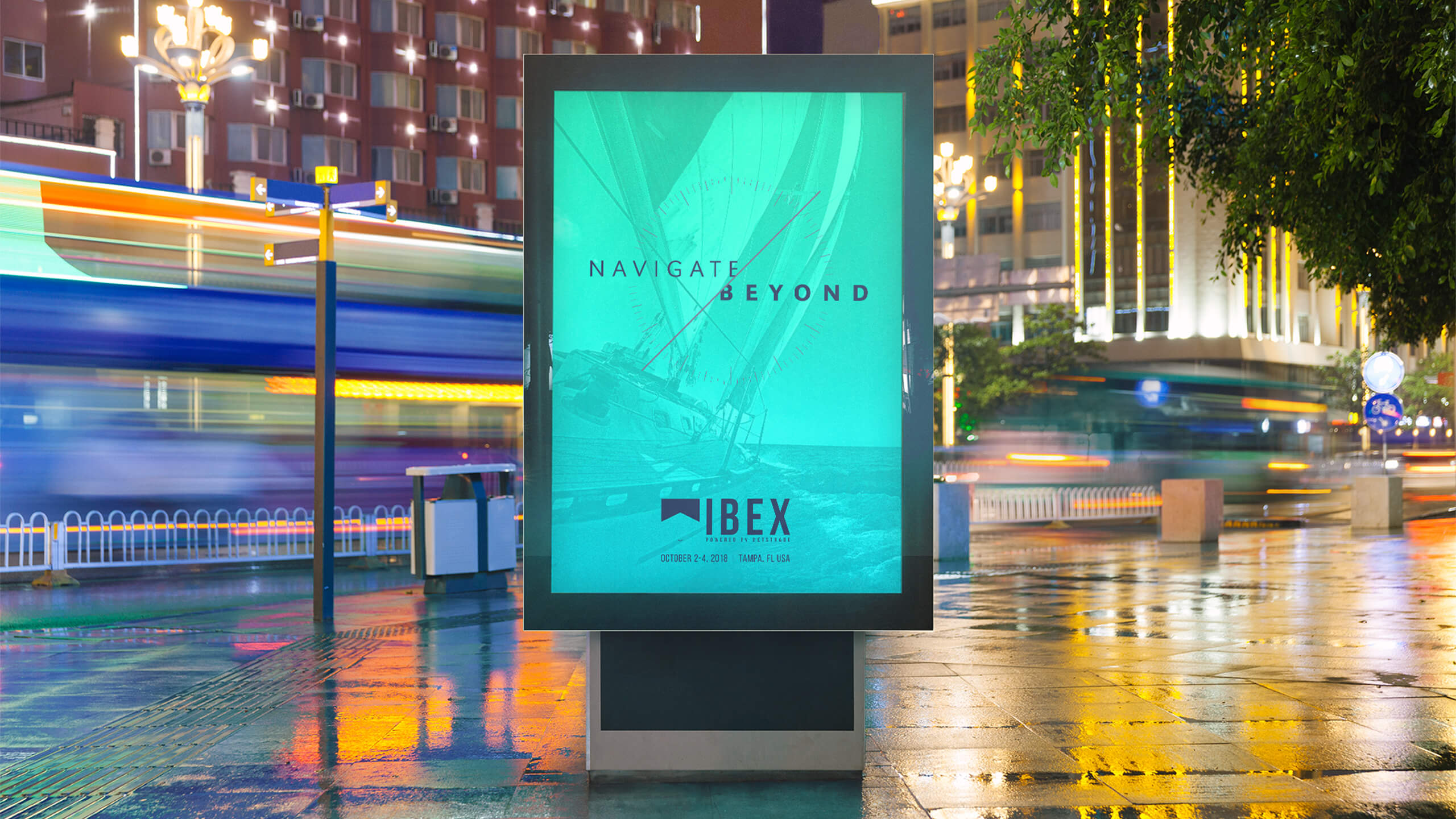 ibex-2018-billboard-mockup Outdoor blue and green sign with black text on top of faded out boat image