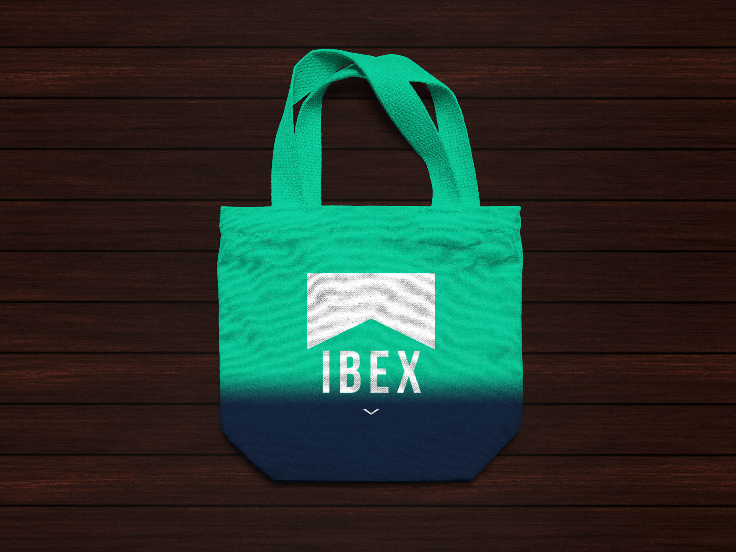ibex-tote-mockup Tote bag that is blue to aqua gradient with the white logo printed on top